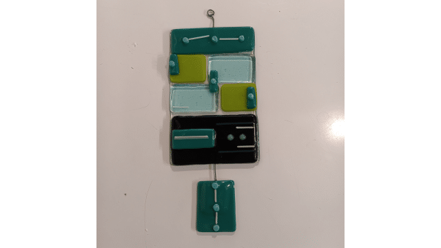 Abstract glass tile artwork with teal, light blue, lime green, and black rectangles on a white background.