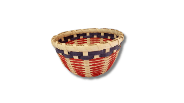 Round woven basket with red, beige, and blue stripes on a white background.